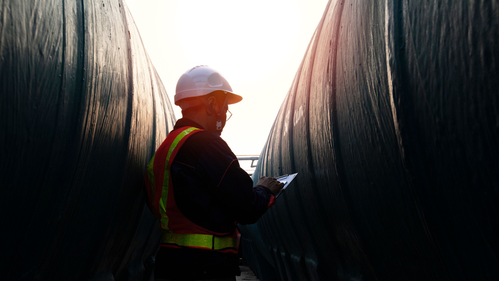 Middle age engineer dress full PPE suit hold radio communication  inspection at site of factory